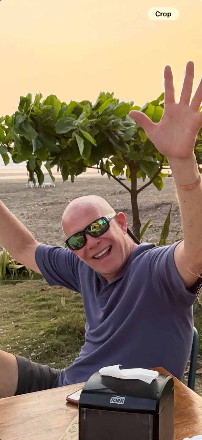 Scott Duff waving on the beach in Tamarindo, Costa Rica